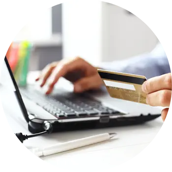 The hand of a person holding a scanner and pointing it at the barcode on the end of an archive box on a shelf